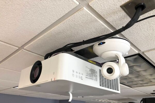 Camera mounted to ceiling and instructor enabled adjustments to the lens to allow the instructor to be "seen" by the camera in more locations around the room