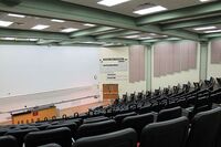 Front of room view with lectern and demonstration bench at left side of room