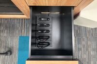 Pedestal - inside view of drawer showing assistive listening devices in charger