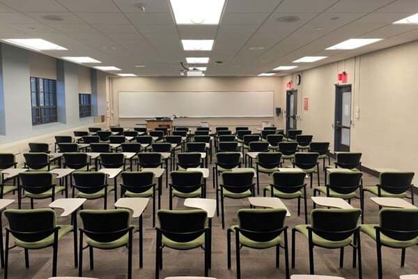 Front of room view with tablet-arm chairs, two exit doors on right