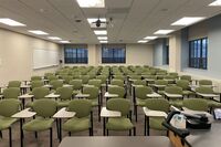 View of back of room with tablet arm chairs 