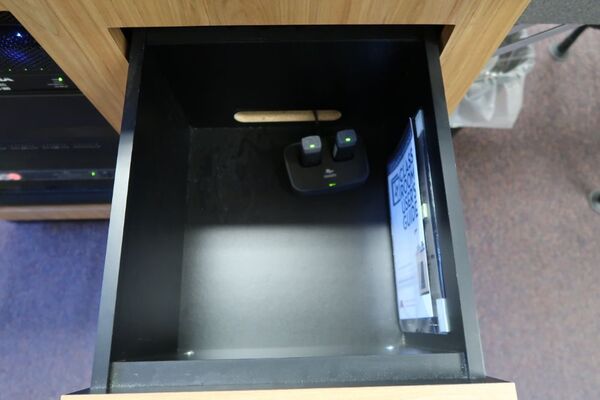 Pedestal - inside view of drawer showing two wireless mics in charging base