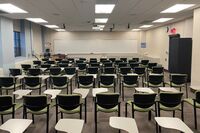 Front of room view with lectern on left in front of markerboard 