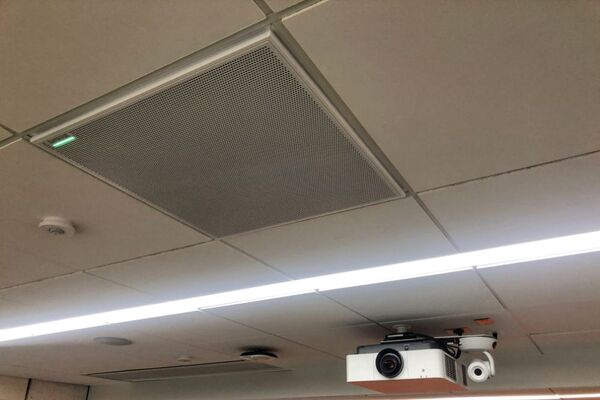 White 2¿ x 2¿ tile mounted in the ceiling to provide microphone coverage over student seating